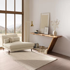 Sculptural console table with asymmetrical leg and open base in modern hallway